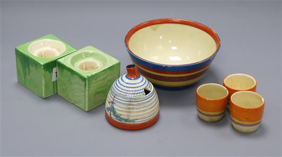 A Clarice Cliff Pine Grove honey jar, an abstract bowl, three egg cups and a pair of cube candleholders diameter 14cm